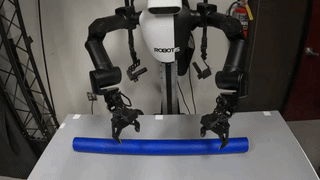 ROBOTIS AI Worker picking up a blue cylinder